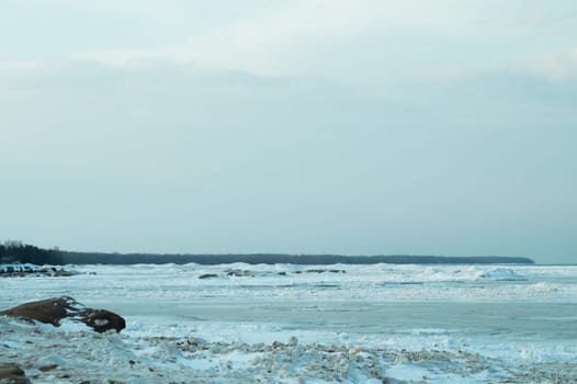 Blue frozen lake with the sky. winter landscape. nature background with a horizon line