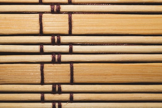 Bamboo mat background close up. wooden backdrop. wooden sticks bound together