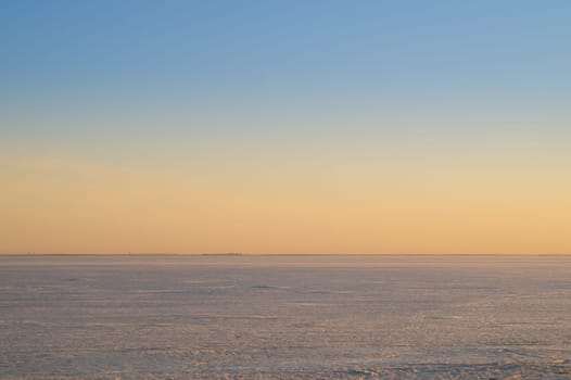 Frozen lake at sunset landscape background. horizon line