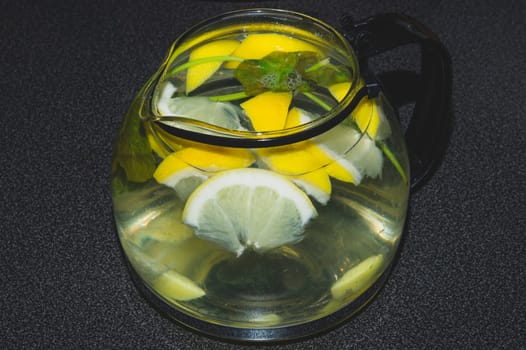 Drink with lemon and mint. homemade lemonade. glass jug with refreshing beverage
