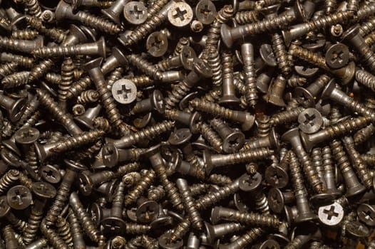 Screws background. heap of tapping screws. work tool. pile of fasteners