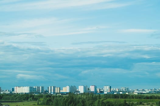 Urban cityscape panoramic view. horizon line with buildings. nature landscape with town and forest. blue sky. city into a distance