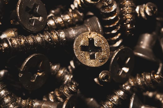 Screws background. heap of tapping screws. work tool. pile of fasteners