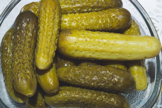 Pickled cucumbers in a bowl. marinated appetizer close up