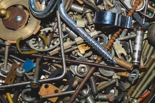 Old screws background. heap of tapping screws. work tool. pile of fasteners. bolts and nuts. metal scrap