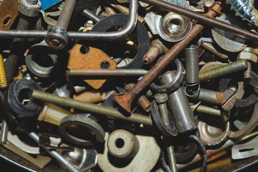 Old screws background. heap of tapping screws. work tool. pile of fasteners. bolts and nuts. metal scrap