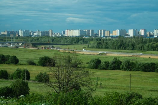 Urban cityscape panoramic view. horizon line with buildings. nature landscape with town and forest. blue sky. city into a distance