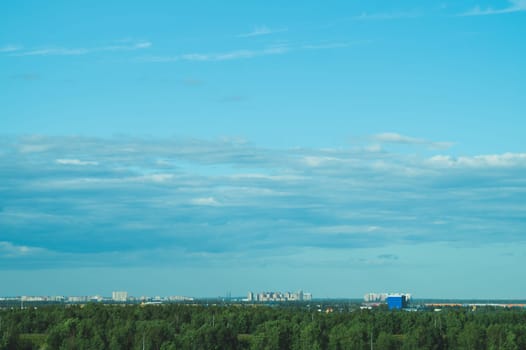 Urban cityscape panoramic view. horizon line with buildings. nature landscape with town and forest. blue sky. city into a distance