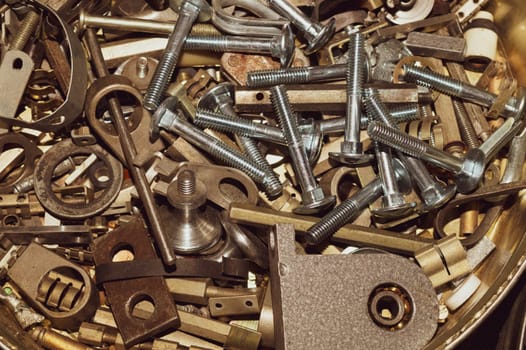 Old screws background. heap of tapping screws. work tool. pile of fasteners. bolts and nuts. metal scrap