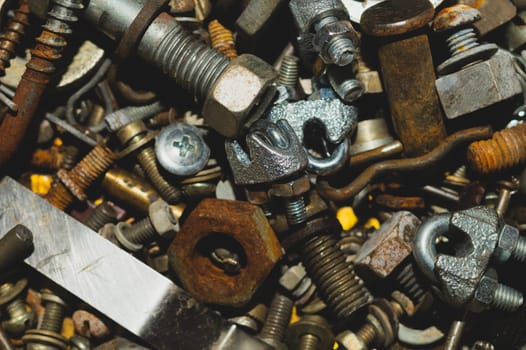 Old screws background. heap of tapping screws. work tool. pile of fasteners. bolts and nuts. metal scrap