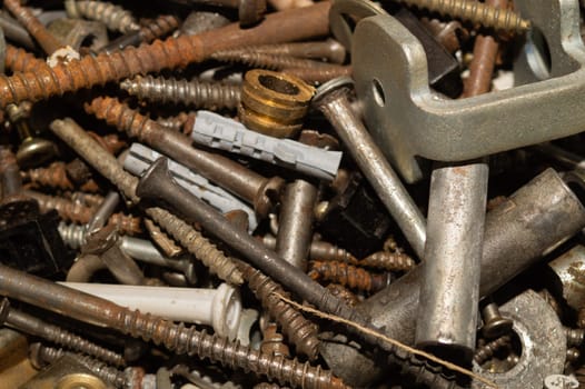 Old screws background. heap of tapping screws. work tool. pile of fasteners. bolts and nuts. metal scrap