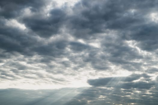 Sunlight shines through the cloudy sky. stormy sky with sunbeam. overcast weather