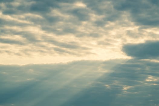 Sunlight shines through the cloudy sky. stormy sky with sunbeam. overcast weather