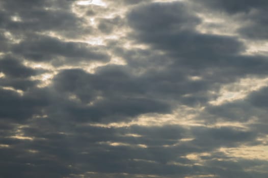 Sunlight shines through the cloudy sky. stormy sky with sunbeam. overcast weather