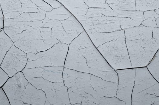 Cracked paint on a wooden surface. grunge texture with peeling paint on wood