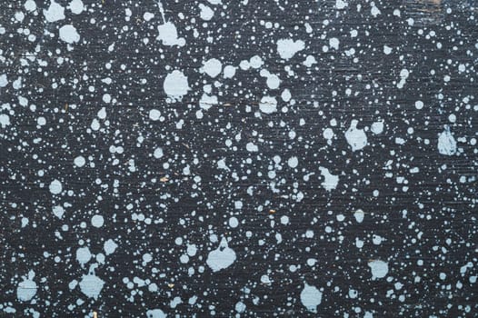 Painted wood surface with spots. wooden background with paint splashes. grunge texture with stains and scratches