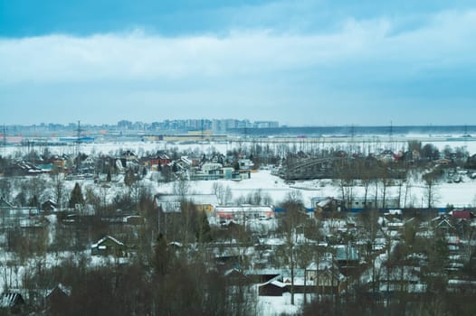 Snow covered houses with the gardens in winter. wooden houses in the forest aerial view. rural landscape from high view