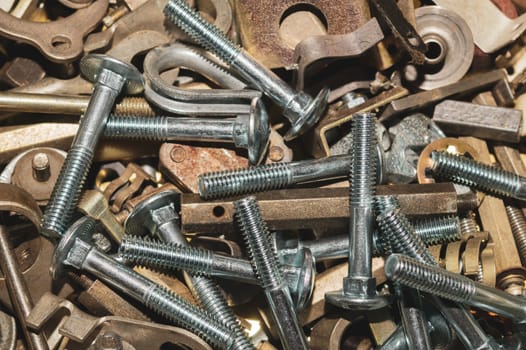 Old screws background. heap of tapping screws. work tool. pile of fasteners. bolts and nuts. metal scrap