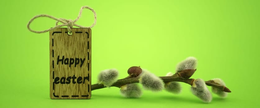 Minimalistic style Easter banner and wooden label with text "Happy Easter"" on green background with free copy space for text"