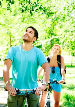 Young man and woman having a bike ride in nature
