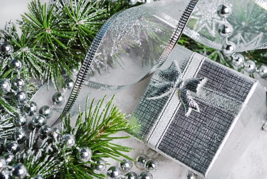 Silver gift box and christmas decoration in snow