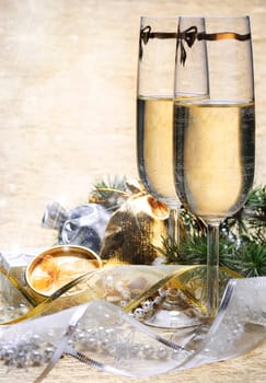Two champagne glasses with presents and decorative ribbon