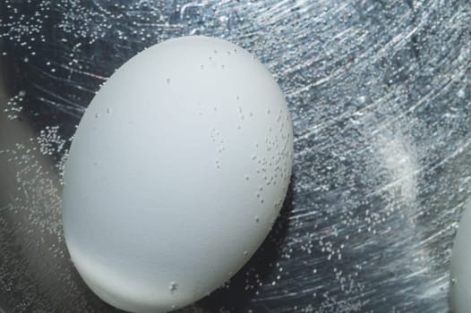 Egg boiled in a pot with hot water
