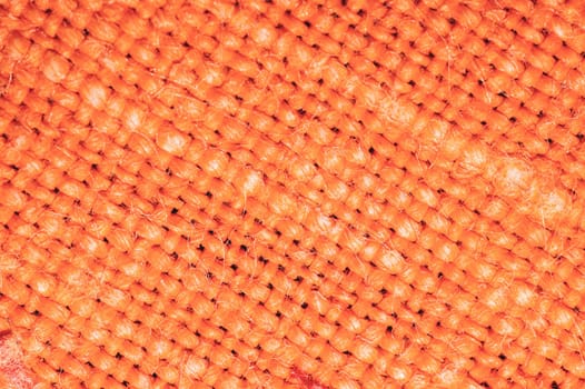 Orange fabric texture. knitted textile background. woven material close up
