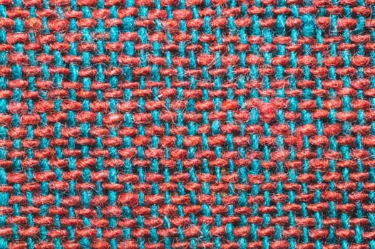 Fabric macro texture. knitted textile close up. woven background. woolen material. weaving red and blue threads