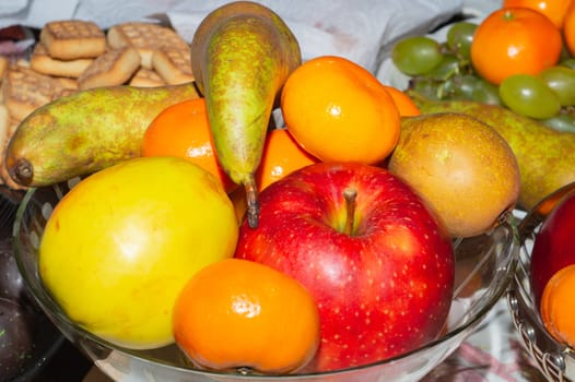 Ordinary fruit plate with natural looking fruits. fresh apples, pears and mandarins