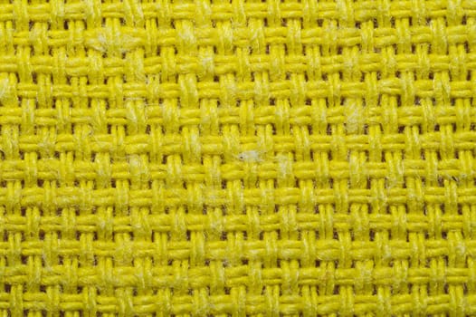 Yellow knitted fabric texture. woven material close up. textile background