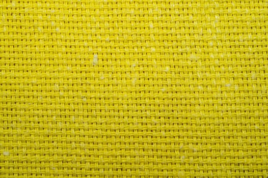 Yellow knitted fabric texture. woven material close up. textile background