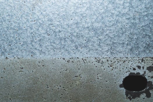 Iron plate macro. metal sheet with hole. steel background close up
