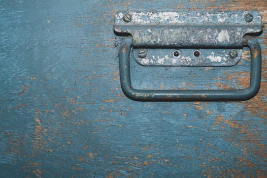 Shabby wood surface with metal handle. old wooden box with cracked paint. abstract background