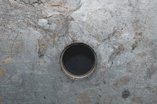 Iron plate macro. metal sheet with hole. steel background close up