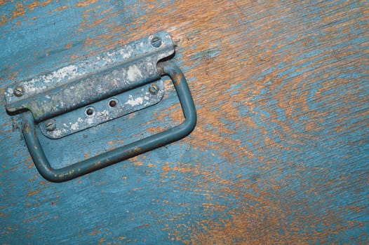 Shabby wood surface with metal handle. old wooden box with cracked paint. abstract background