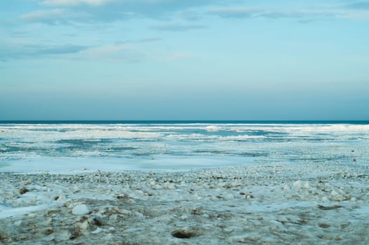 Blue frozen lake with the sky. winter landscape. nature background with a horizon line