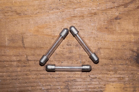 Fuse on wooden background. safety device for overcurrent protection. protection of an electrical circuit