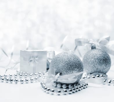 Silver christmas ornaments with bokeh background