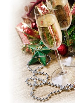 Two champagne glasses and christmas ornaments