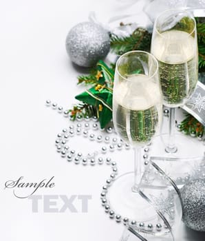 Two champagne glasses and christmas ornaments