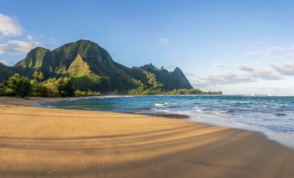 Beautiful Tunnels Beach at dawn on the island of Kauai, Hawaii with slanting shadows from rising sun