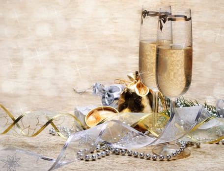Two champagne glasses with presents and decorative ribbon
