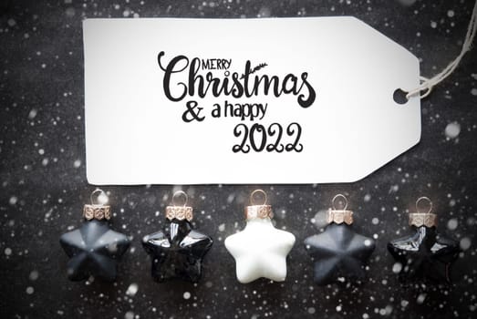 Label With English Calligraphy Merry Christmas And A Happy 2022. Black Christmas Ball Ornament With Snowflakes