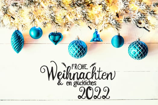 Christmas Decoration With German Calligraphy Frohe Weihnachten Und Ein Glueckliches 2022 Mean Merry Christmas And A Happy 2022. Fir Tree Branch With Shiny Fairy Lights