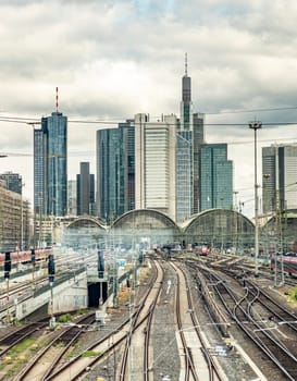 entering the Frankfurt train station with view to skyscraper with cloudy sky