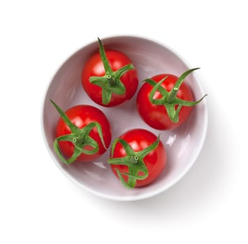 Cherry tomatoes in white bowl isolated on white background. Top view
