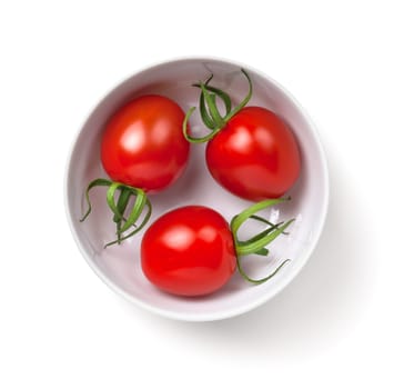 Three cherry tomatoes in white bowl isolated over white background. Top view