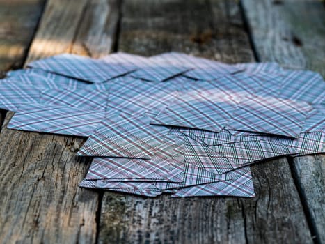 A deck of playing cards on a wooden table. A deck of playing cards. Gambling. Summer rest. Background image. Game table. Place for your text.