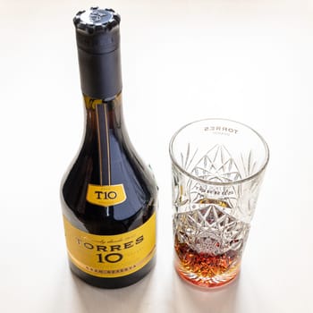 Moscow, Russia - October 16, 2021: TORRES Gran Reserva 10 spanish brandy and and crystal tumbler. Torres 10 Gran Reserva is the most popular Spanish brandy in world, it has been produced since 1946